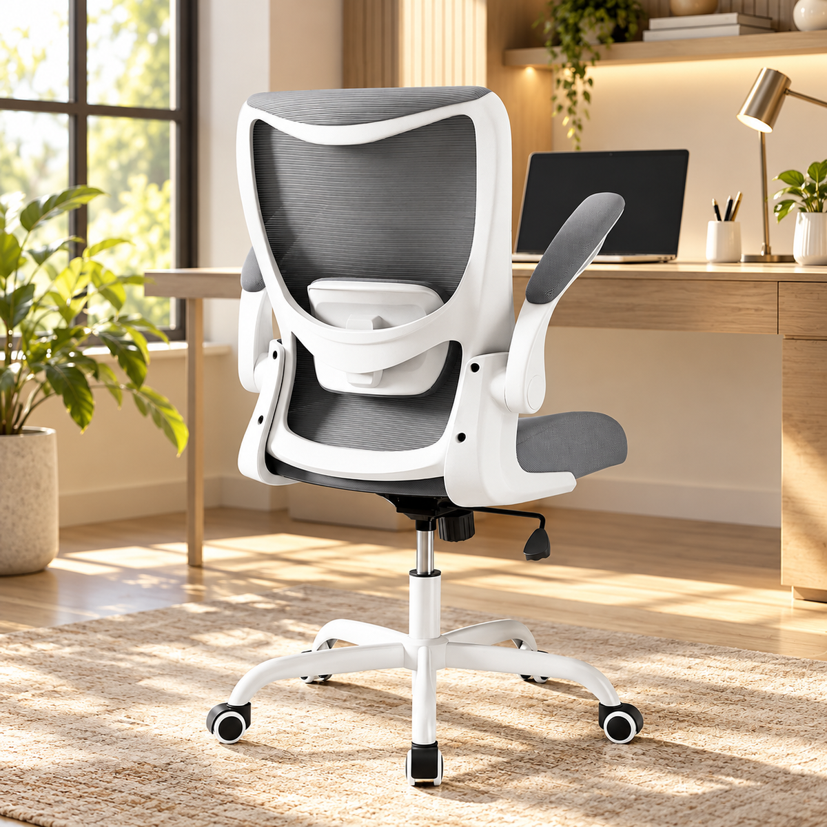 Grey mid-back mesh ergonomic office chair with white frame and flip-up arms at a desk