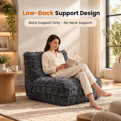 Woman reading in the low-back faux fur bean bag chair; back support only, no neck support