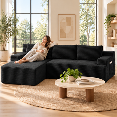 Woman relaxing on the chaise of the black corduroy cloud sectional in a sunlit living room