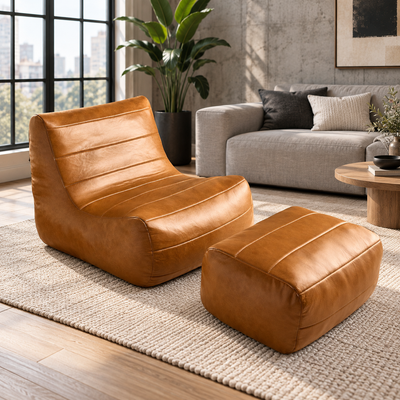 Cognac faux leather high-back bean bag chair with matching ottoman in a living room
