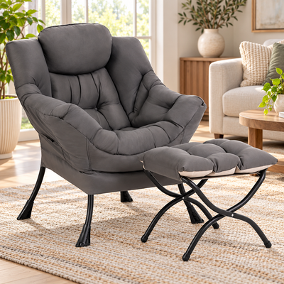 Gray lazy reading chair with tufted cushions and folding X-frame ottoman in a living room