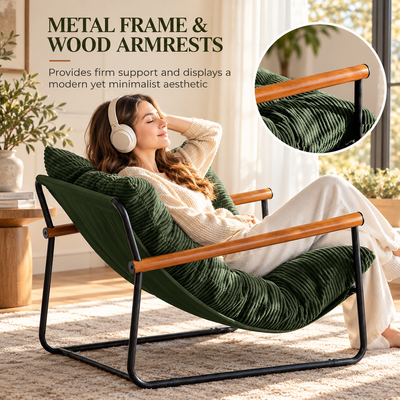 Woman with headphones relaxing in the sling chair, showing the metal frame and wood armrests