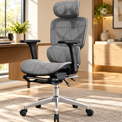 Grey oversized ergonomic mesh office chair with headrest, 4D armrests, pull-out footrest and silver base in a home office
