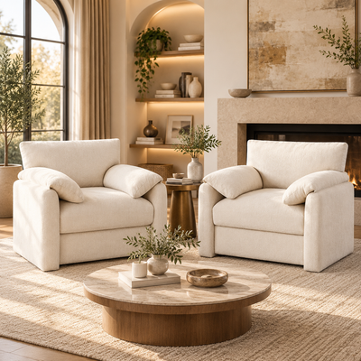 Pair of oversized cream armchairs around a round wood coffee table