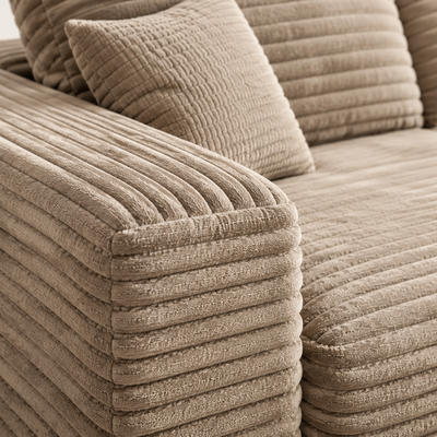 Close-up of the plush ribbed fabric on the wide arm and pillow