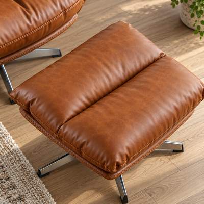 Close-up of the padded faux leather ottoman on its swivel metal base