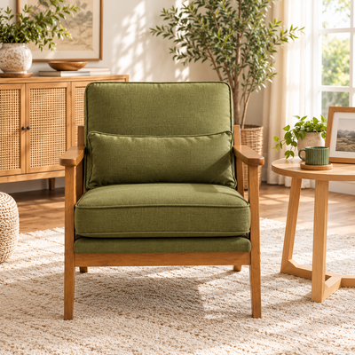Front view of the olive green mid-century accent chair beside a round wood side table